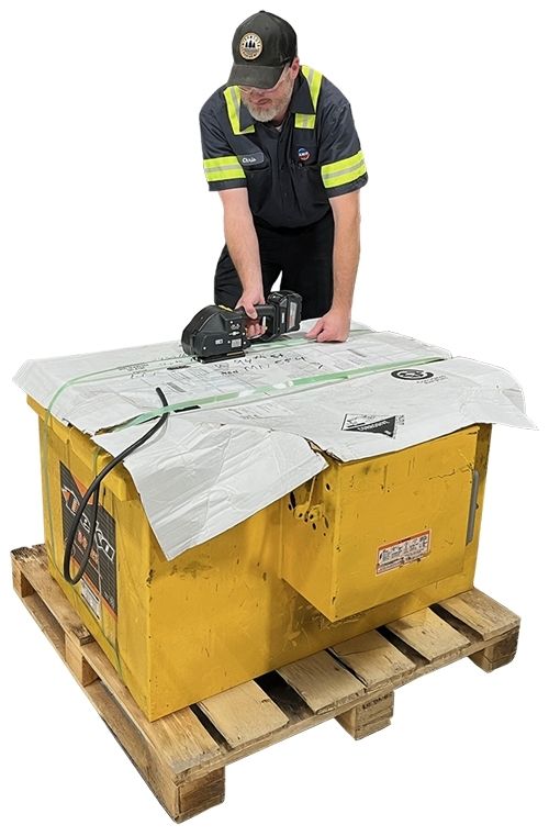 Technician banding a forklift battery to a pallet.