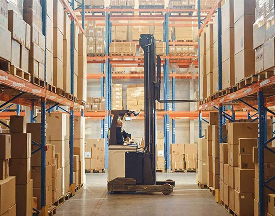 Retail warehouse shelves, Electric Forklift Truck operator lifting pallet in logistics center.